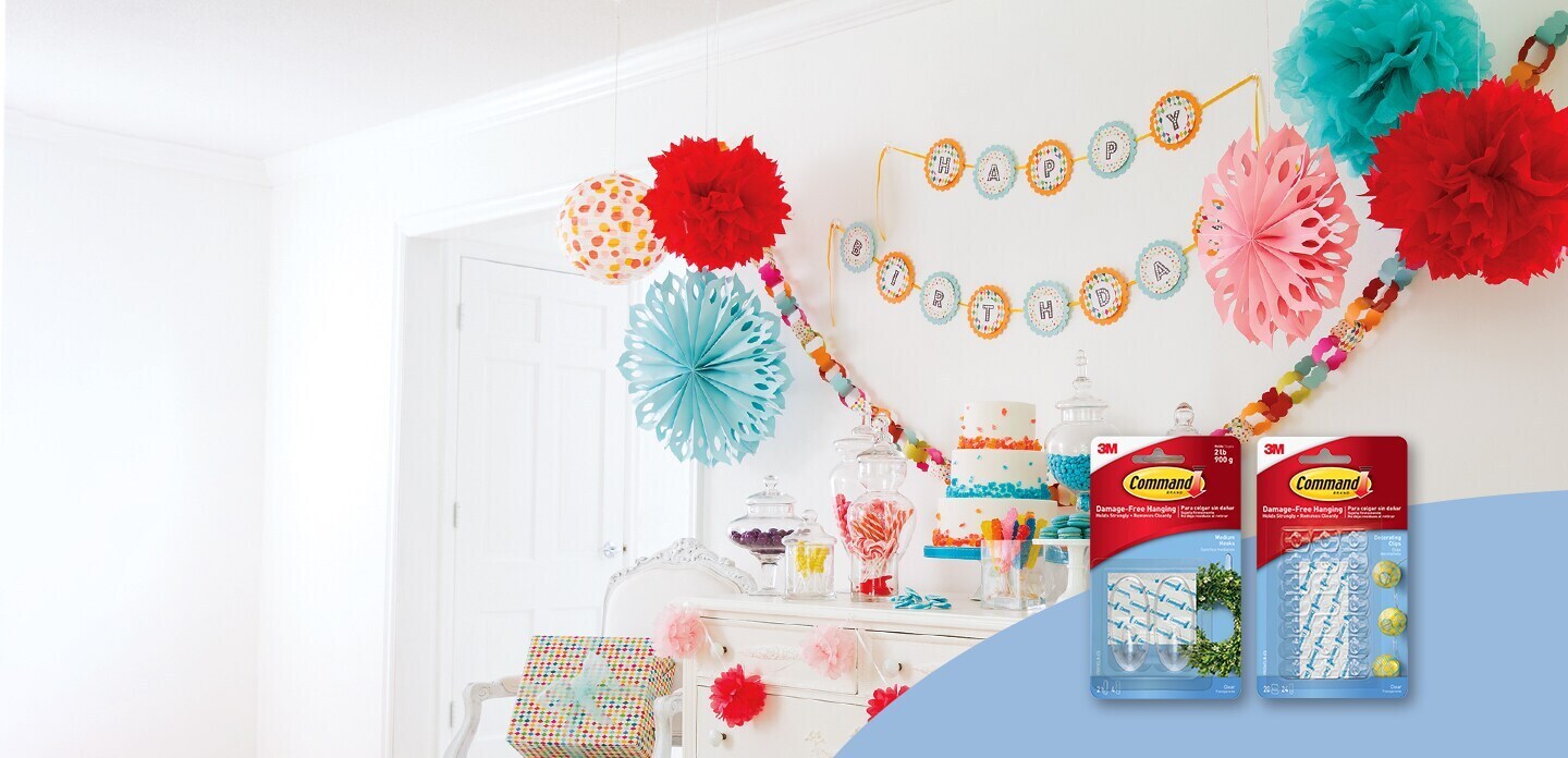 Party banners and garlands hung using damage-free adhesive hooks
