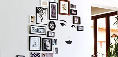 face wall decal with frames mounted with command picture hanging strips
