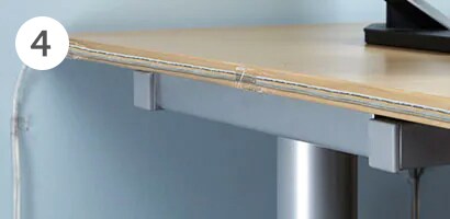 Cords organized on the desk in a home office
