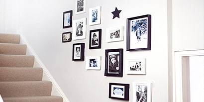 organic gallery wall ideas used along stairway
