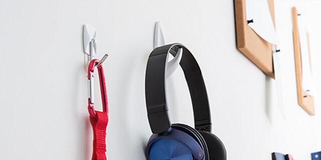 headphone and other accessories hung with command adhesive wall hangers